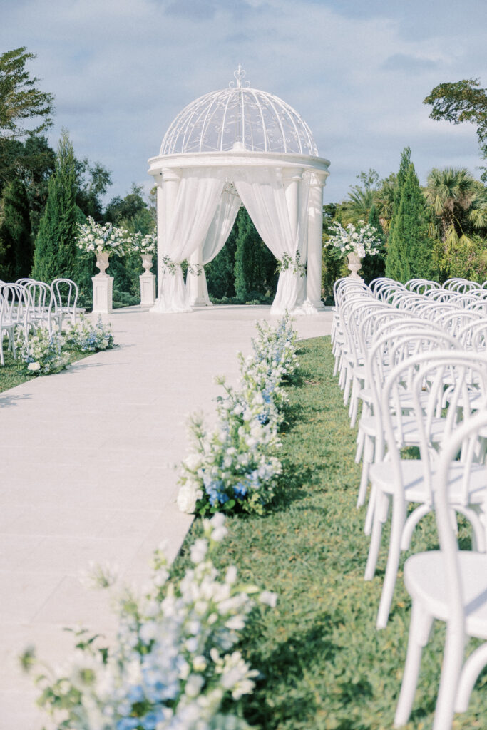 Outdoor wedding ceremony set up with chairs and florals, South Florida Wedding Venue 